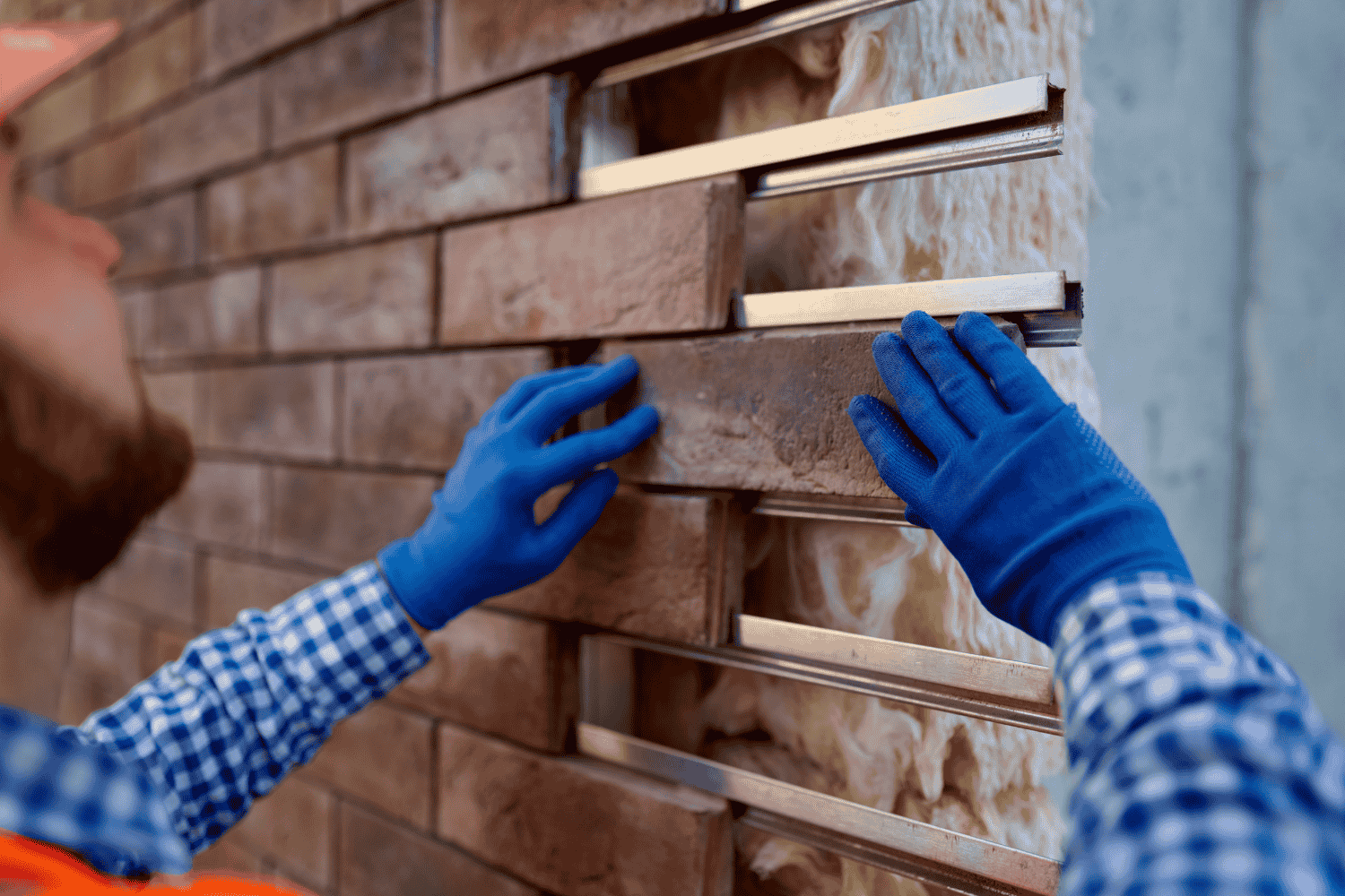 A professional contractor installing new siding on a home.