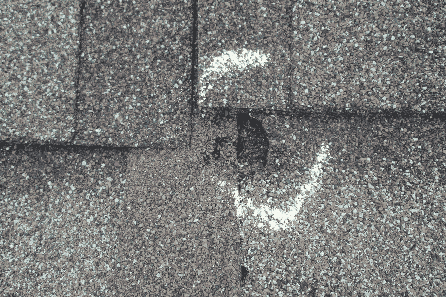 A close-up view of a roof showing visible hail damage, illustrating how to tell if your roof has hail damage.