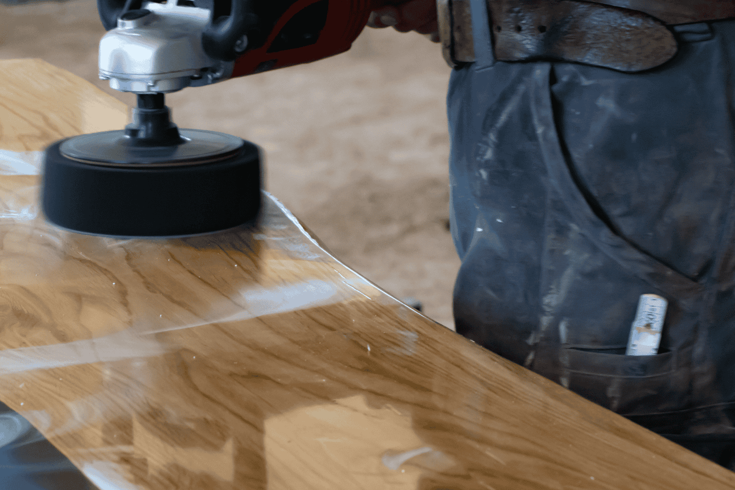 Applying epoxy to repair rotted wood.