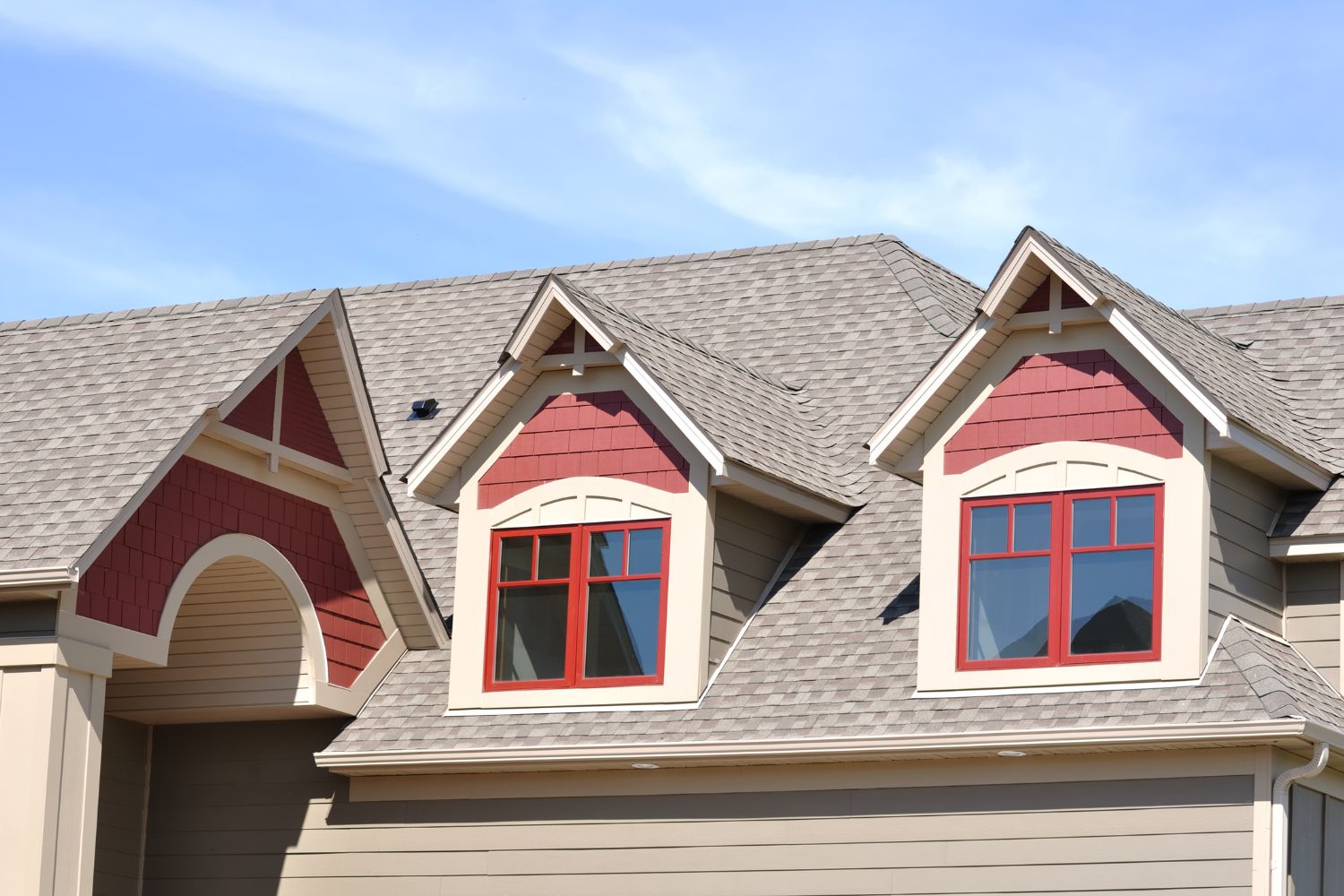 A house with red siding exterior and shingle roofing