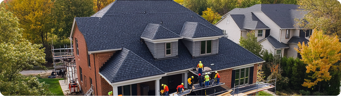 Aerial view of a roofing crew installing a new residential roof